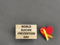 Celebration Day Concept - world suicide prevention day text on wooden blocks with gray background. Stock photo.