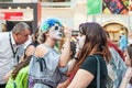 Celebration of the Day of the Dead. Girl with makeup doing face painting to another girl Royalty Free Stock Photo