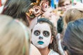 Celebration of the Day of the Dead. Girl with makeup doing face painting to another girl Royalty Free Stock Photo