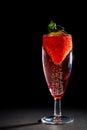 Celebration drink. Bubbly pink champagne glass with strawberry. Royalty Free Stock Photo