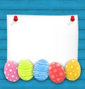 Celebration empty paper card with Easter ornamental eggs on wood