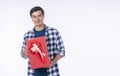 Celebration festive Christmas, new year, birthday and valentine concept. Positive handsome cool young man holding red gift box Royalty Free Stock Photo