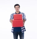 Celebration festive Christmas, new year, birthday and valentine concept. Positive handsome cool young man holding two red gift box Royalty Free Stock Photo