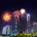 Celebration firework in twilight night cityscape of guangzhou urban skyscrapers at storm with lightning  bolts in night purple Royalty Free Stock Photo