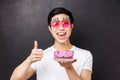 Celebration, holiday and birthday concept. Close-up portrait of excited happy b-day guy in funny party glasses, show Royalty Free Stock Photo