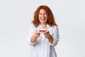 Celebration, holidays and emotions concept. Cheerful and upbeat redhead middle-aged woman enjoying party in her honor