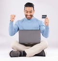 Celebration, laptop and asian man with credit card in studio excited for cashback bonus on grey background. Online