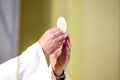 Host that in the hands of the priest, as in the hands of Pope Francis, becomes the body of Christ Royalty Free Stock Photo