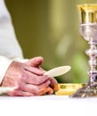 Host that in the hands of the priest, as in the hands of Pope Francis, becomes the body of Christ Royalty Free Stock Photo