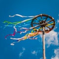 Celebration of Midsummer. Wooden wheel with bright ribbons