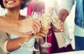 Friends clinking glasses of champagne at party