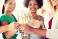 Friends clinking glasses of champagne at party