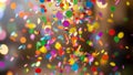 Colorful confetti and streamers falling and exploding in a celebration with blurred bokeh lights in the background creating a Royalty Free Stock Photo