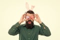 Celebration of spring holiday. Culture customs and traditions. Easter bunny colored eggs. Bearded man with bunny ears