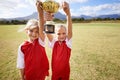 Celebration, teammates and children with cup, boys and girls with victory, support or proud. Achievement, sports and Royalty Free Stock Photo