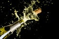 Celebration theme with explosion of splashing champagne sparkling wine on black background.