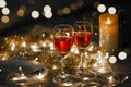 Celebration theme with two red wine glass on small gold light background