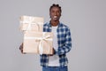 Celebration Time. Portrait of happy black guy holding stack of present boxes Royalty Free Stock Photo