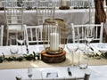 Celebration venue tables decorated with white table cloth and candles Royalty Free Stock Photo