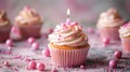 Celebratory Birthday Cupcake with Pink Decoration and Candle Royalty Free Stock Photo