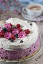 Celebratory cake with berries and a cup of aromatic coffee. Vintage napkin, spoon and pink flowers