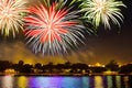 Celebratory fireworks over the city by the water, generative AI Royalty Free Stock Photo