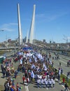 A celebratory parade in honor of the first Maya. people walk on the bridge