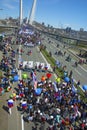 A celebratory parade in honor of the first Maya. people walk on the bridge