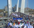 A celebratory parade in honor of the first Maya. people walk on the bridge