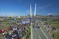 A celebratory parade in honor of the first Maya. people walk on the bridge