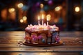 Celebratory setup cakes on wooden floor, featuring a glowing candle