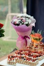 Celebratory table for the eighteenth birthday with a cake and a bouquet of flowers Royalty Free Stock Photo