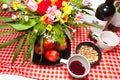 Celebratory table red wine flowers apples pistachios