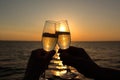 Celebratory Toast With Sparkling Wine At Sunset Sky And Sea In The Background - Generative AI