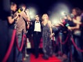 Celebrity couple arriving a premiere with paparazzi cameras and flashes Royalty Free Stock Photo