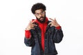 Celebrity posing paparazzi. Self-satisfied cool and arrogant african american bearded male rapper with afro hairstyle Royalty Free Stock Photo