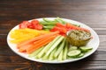 Celery and other vegetable sticks with dip sauce on wooden table Royalty Free Stock Photo