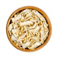 Celery root, celeriac, dehydrated slices, in a wooden bowl