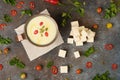 Celery root soup in copper cup on dark background.