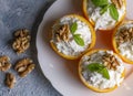 Celery salad with apple and walnuts served in orange cups