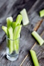 Celery in small the glass on wood