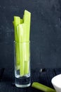 Celery in small the glass on wood