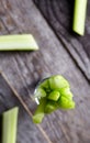 Celery in small the glass on wood