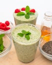 Celery spinach banana smoothie with Chia seeds, honey, fresh raspberries and mint leaves close up Royalty Free Stock Photo