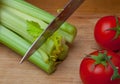 Celery and tomatoes on a cutting board Royalty Free Stock Photo