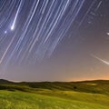 1565 Celestial Meteor Shower: A mesmerizing and celestial background featuring a meteor shower with shooting stars, cosmic dust,