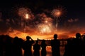 Celestial show Peoples silhouettes admire fireworks, a dazzling night display