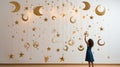 a celestial-themed mobile with golden stars and crescent moons suspended against a pure white backdrop