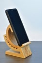 Cell phone adjustable angle wood base. Tabletop wooden smart phone holder.