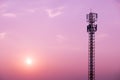 Cell Phone Antenna Tower on purple sky and sun Royalty Free Stock Photo